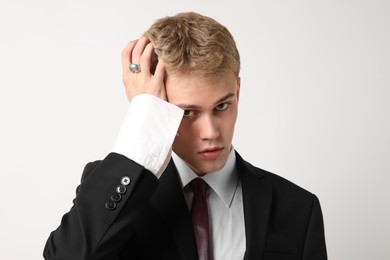Photo of Handsome young man wearing stylish suit on white background