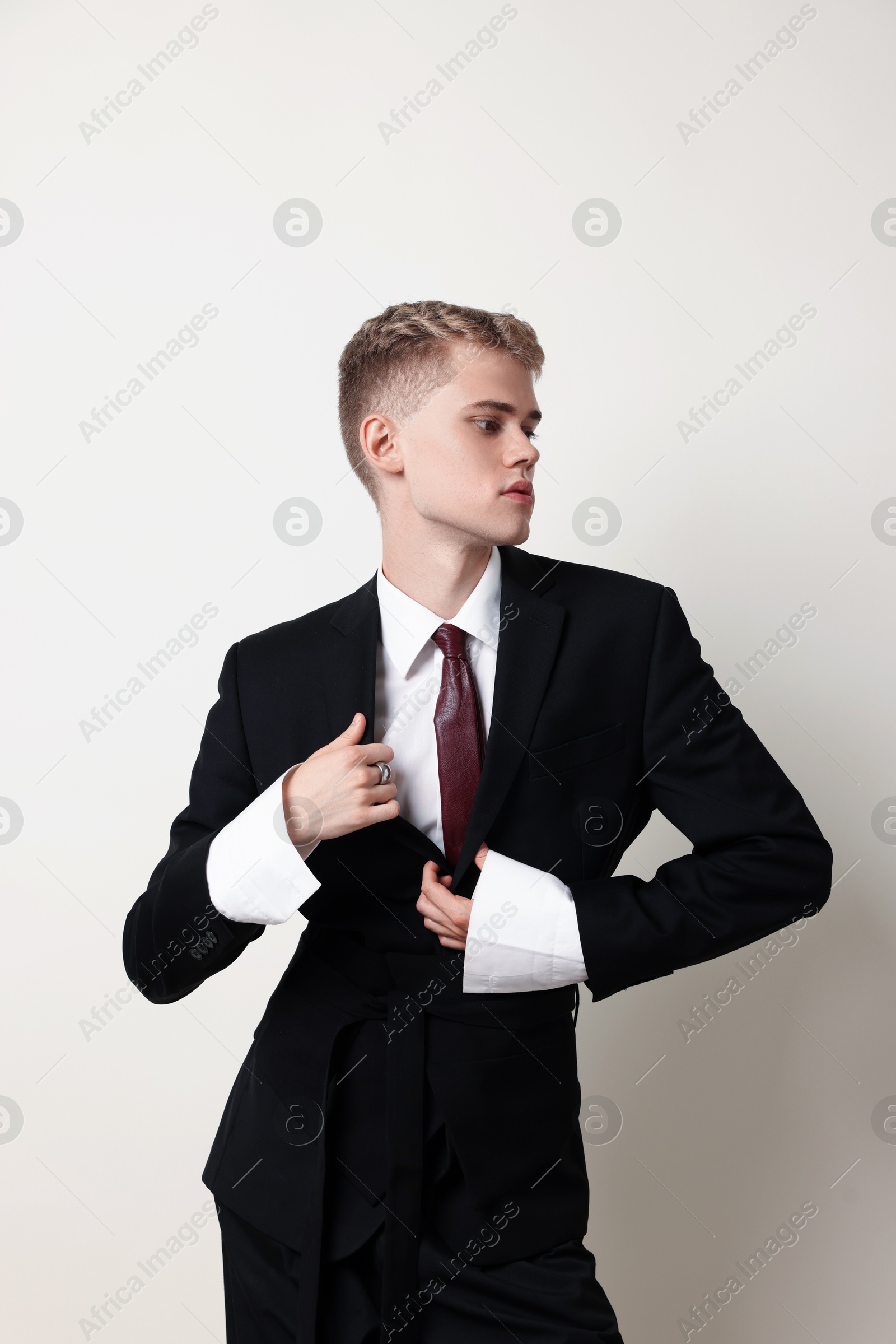 Photo of Handsome young man wearing stylish suit on white background