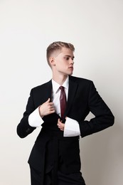 Photo of Handsome young man wearing stylish suit on white background