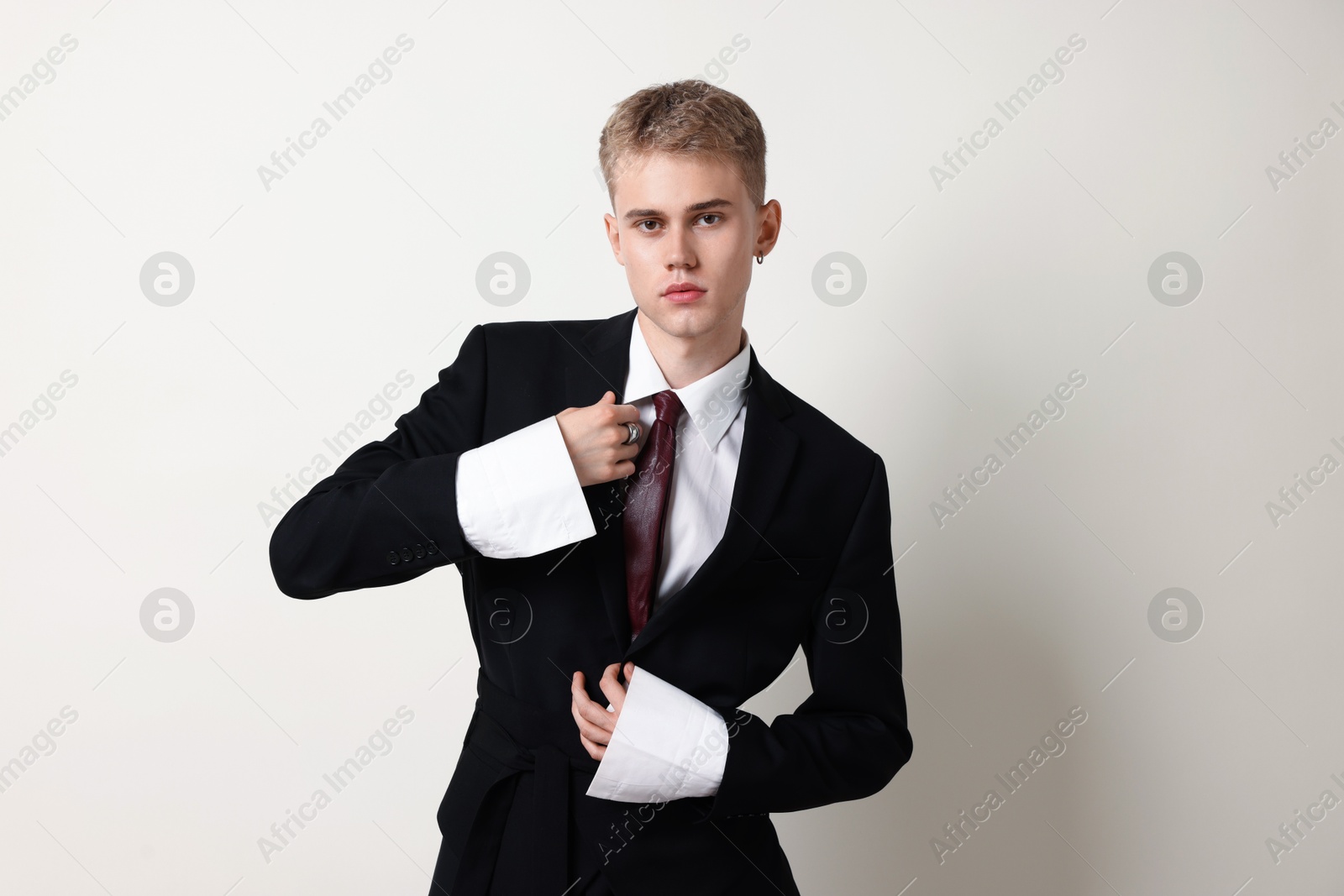 Photo of Handsome young man wearing stylish suit on white background