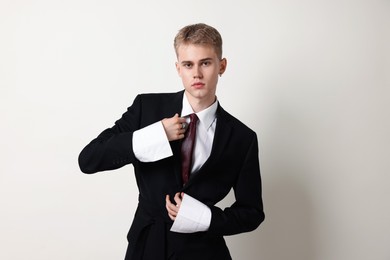 Photo of Handsome young man wearing stylish suit on white background
