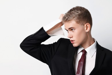 Photo of Handsome young man wearing stylish suit on white background
