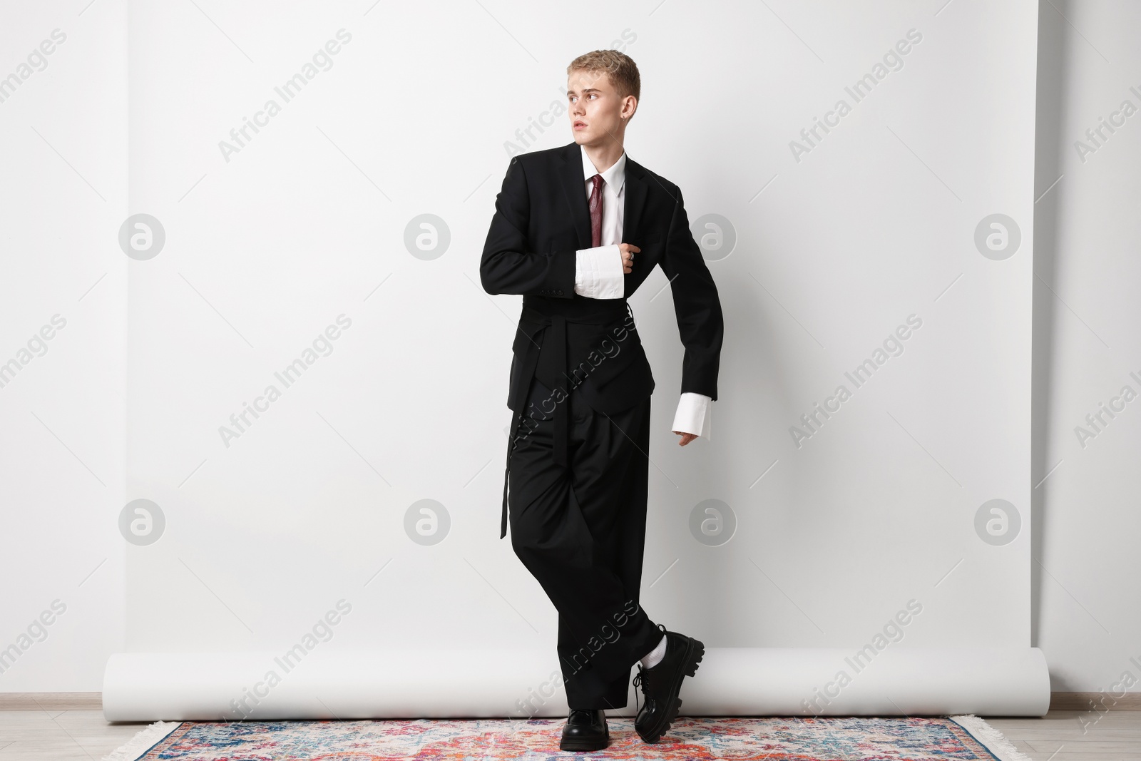 Photo of Handsome young man wearing stylish suit on white background