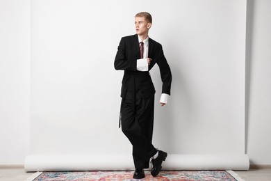 Photo of Handsome young man wearing stylish suit on white background