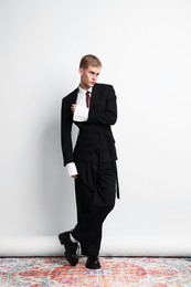 Photo of Handsome young man wearing stylish suit on white background