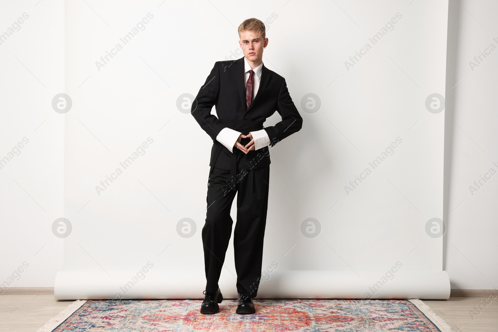 Photo of Handsome young man wearing stylish suit on white background
