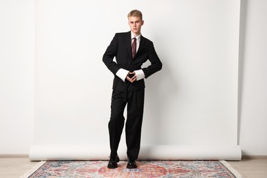 Photo of Handsome young man wearing stylish suit on white background