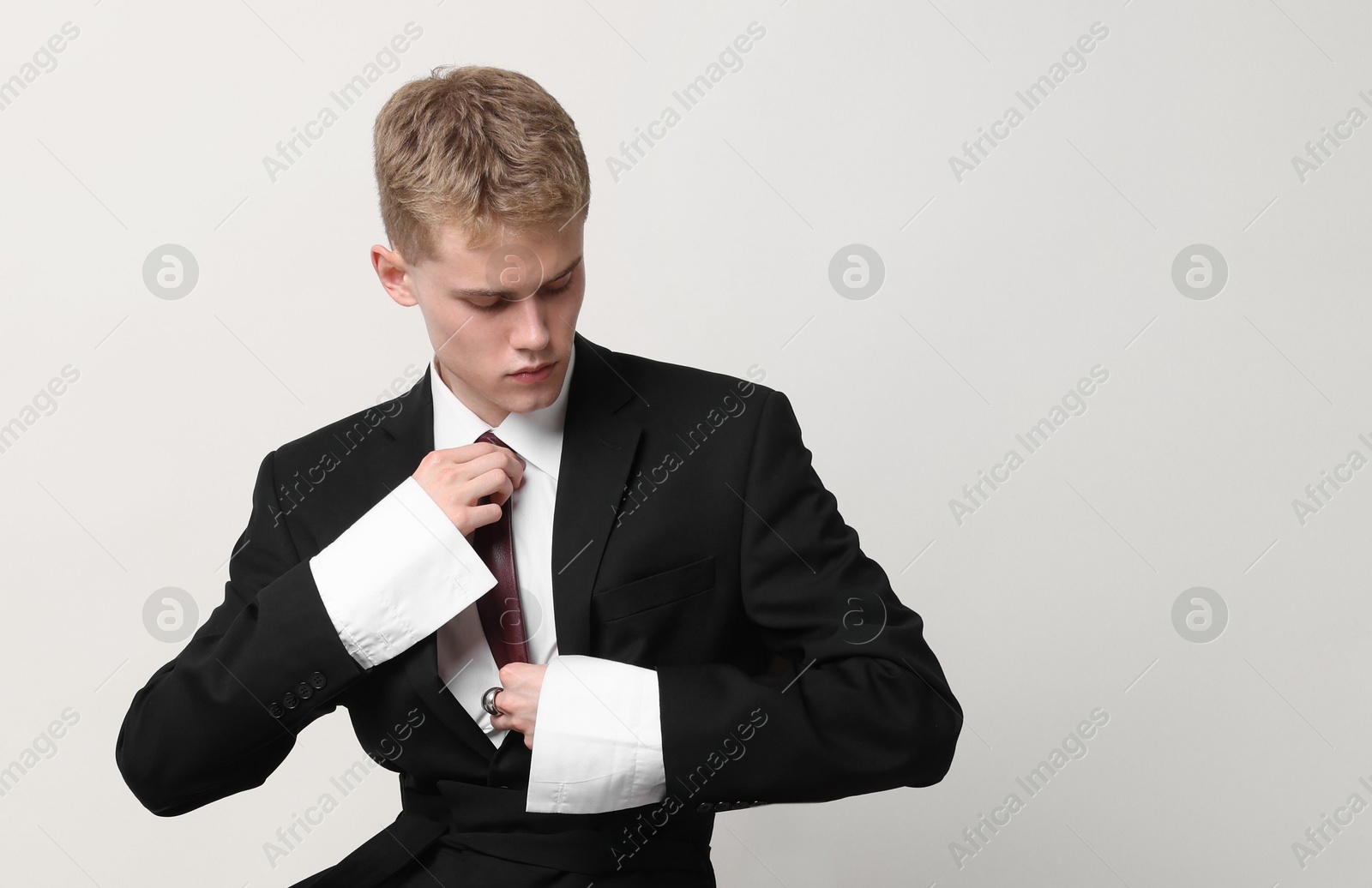 Photo of Handsome young man wearing stylish suit on white background, space for text