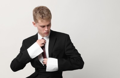 Photo of Handsome young man wearing stylish suit on white background, space for text