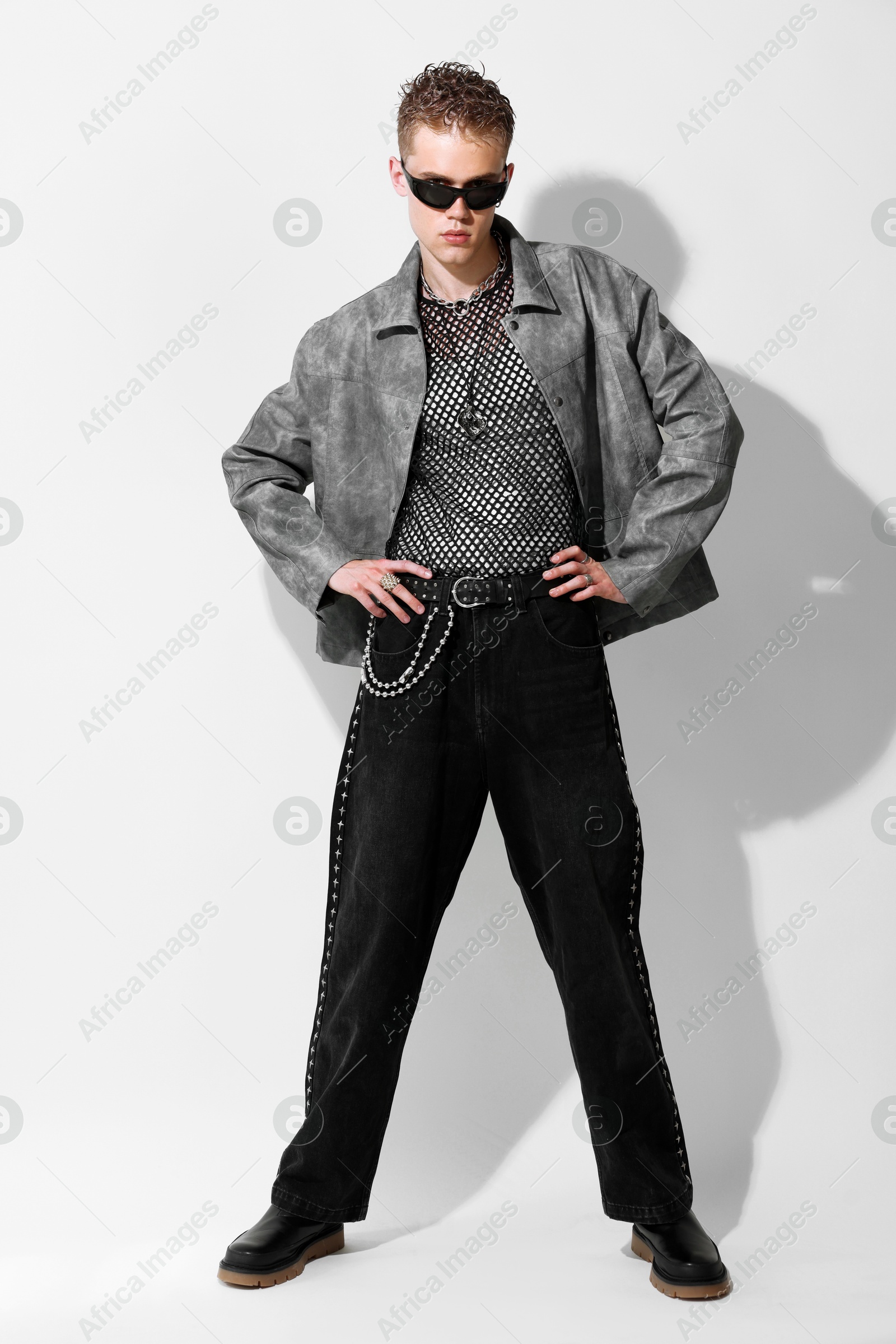 Photo of Handsome young man wearing stylish jacket and sunglasses on white background