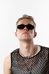 Photo of Handsome young man wearing sunglasses on white background