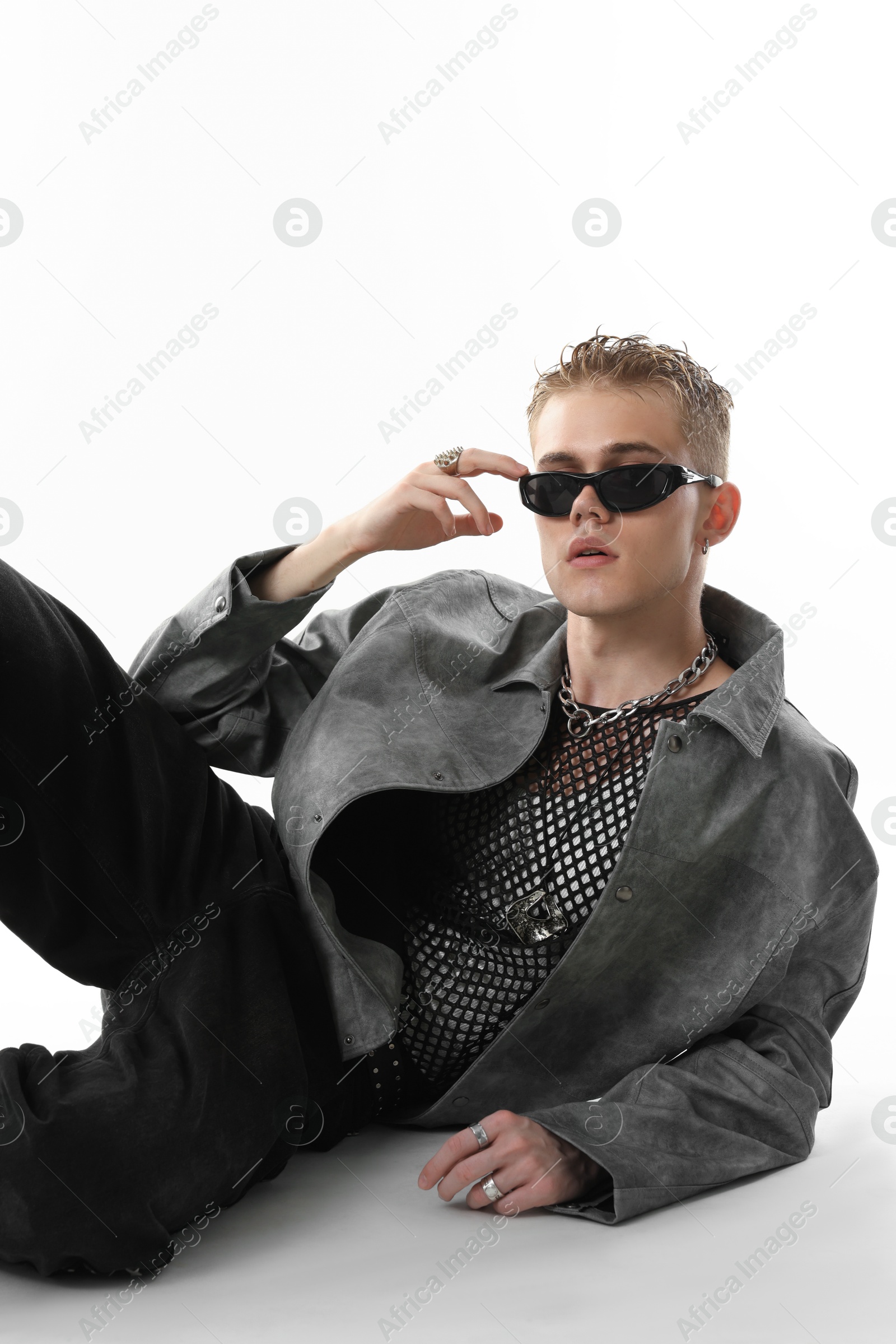 Photo of Handsome young man wearing stylish jacket and sunglasses on white background