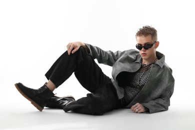 Photo of Handsome young man wearing stylish jacket and sunglasses on white background