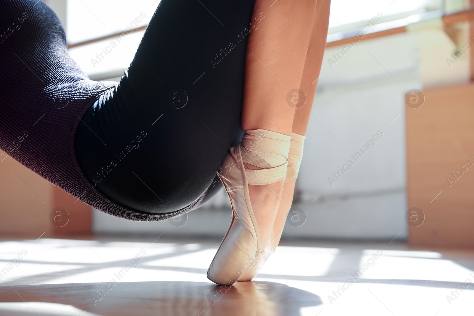 Teenage girl in pointe shoes training indoors, closeup Photo of Teenage girl in pointe shoes training indoors, closeup