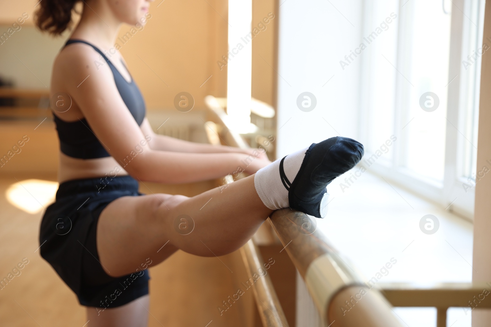 Teenage girl stretching in barre studio, closeup Photo of Teenage girl stretching in barre studio, closeup