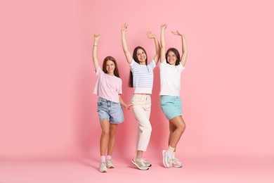 Photo of Portrait of happy friends on pink background