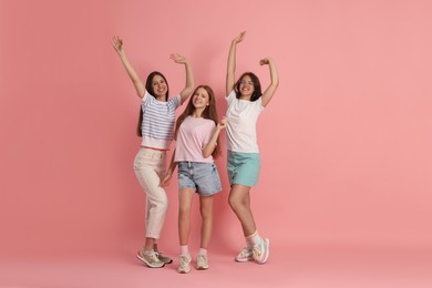 Photo of Portrait of happy friends on pink background