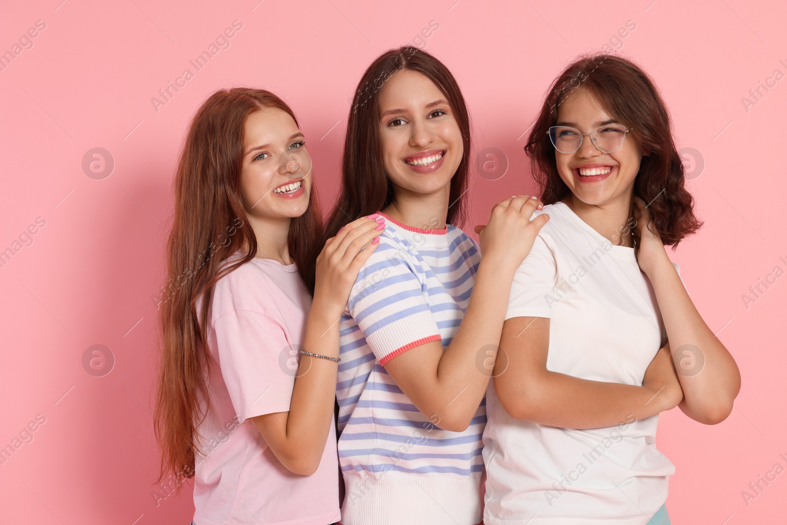 Portrait of happy friends on pink background Photo of Portrait of happy friends on pink background