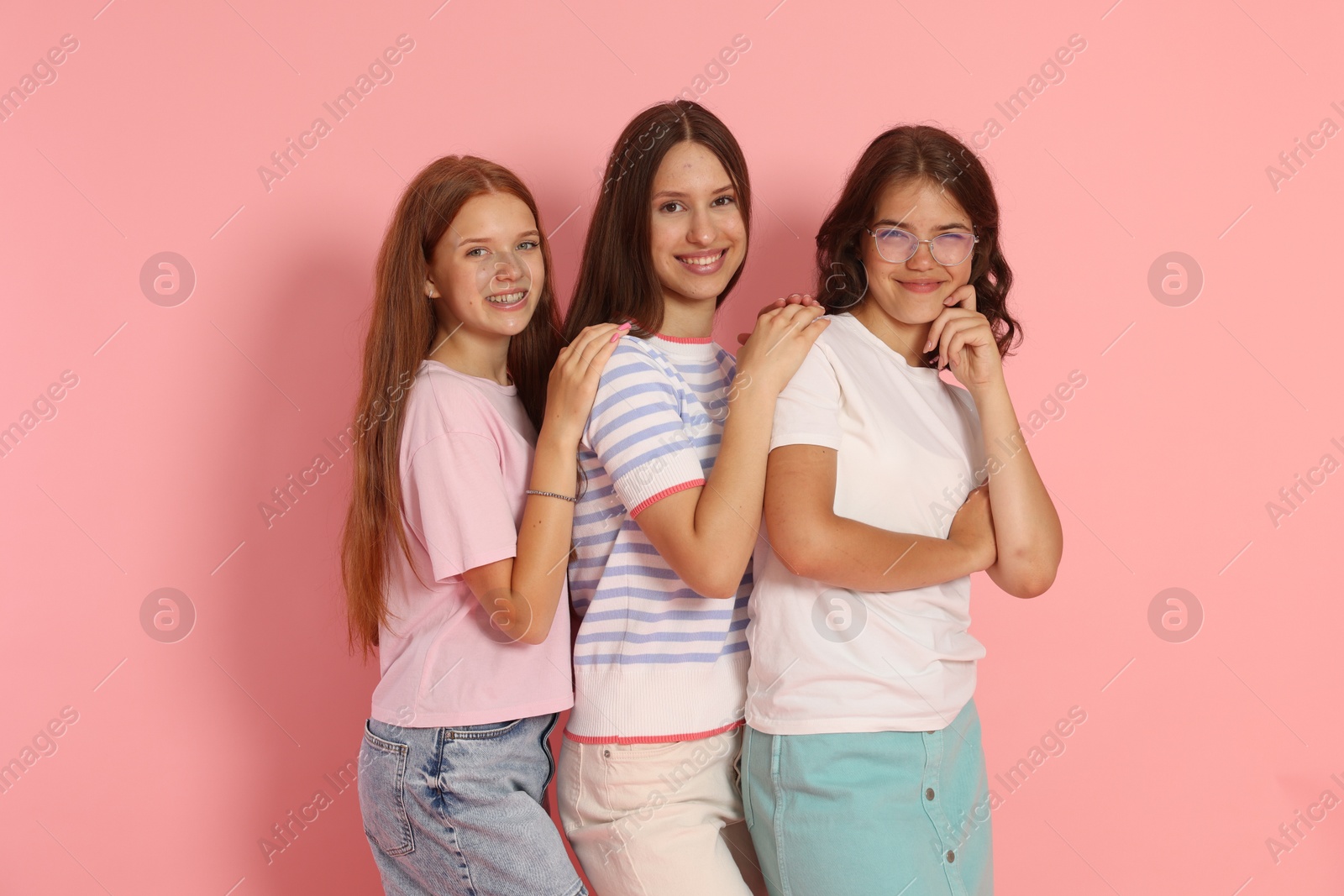 Portrait of happy friends on pink background Photo of Portrait of happy friends on pink background