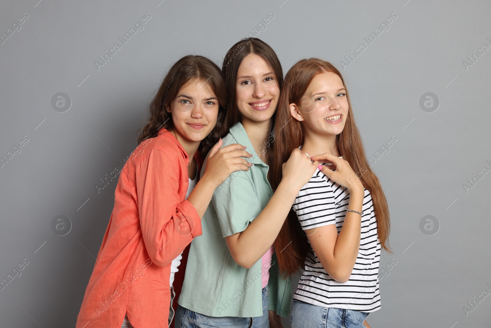 Portrait of happy friends on grey background Photo of Portrait of happy friends on grey background