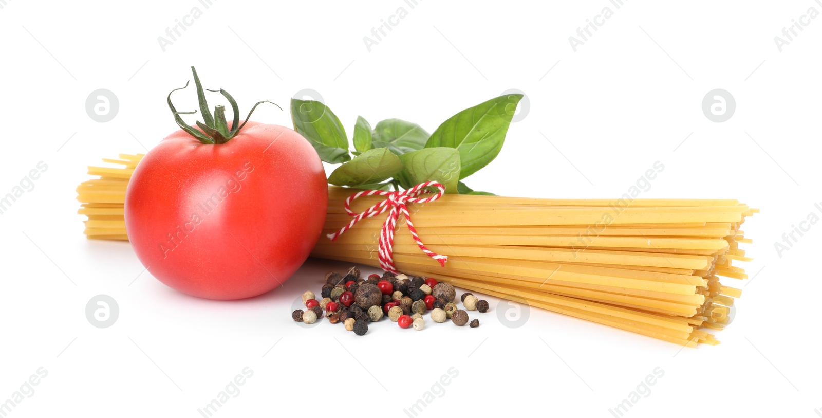 Photo of Raw spaghetti pasta and different ingredients isolated on white