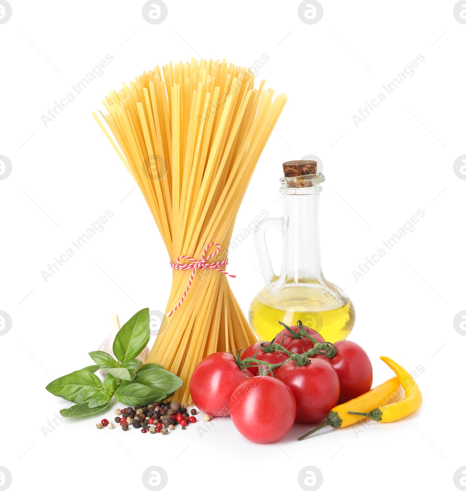 Photo of Raw spaghetti pasta and different ingredients isolated on white