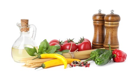Photo of Raw spaghetti pasta and different ingredients isolated on white