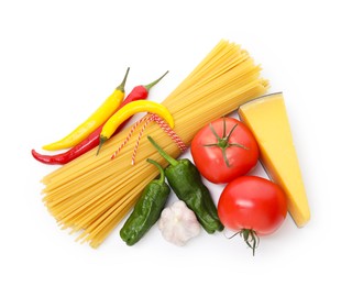 Photo of Raw spaghetti pasta and different ingredients isolated on white, top view