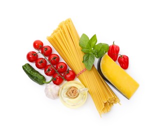 Photo of Raw spaghetti pasta and different ingredients isolated on white, top view