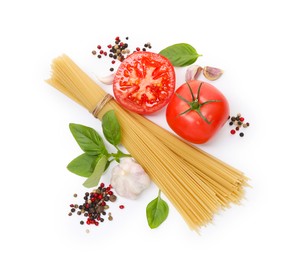 Photo of Raw spaghetti pasta and different ingredients isolated on white, top view