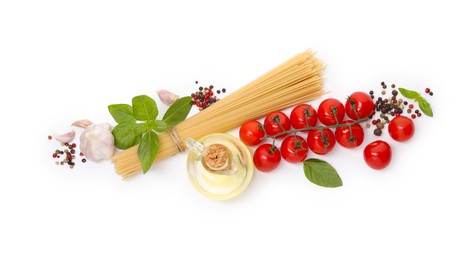 Photo of Raw spaghetti pasta and different ingredients isolated on white, top view