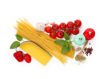 Photo of Raw spaghetti pasta and different ingredients isolated on white, top view