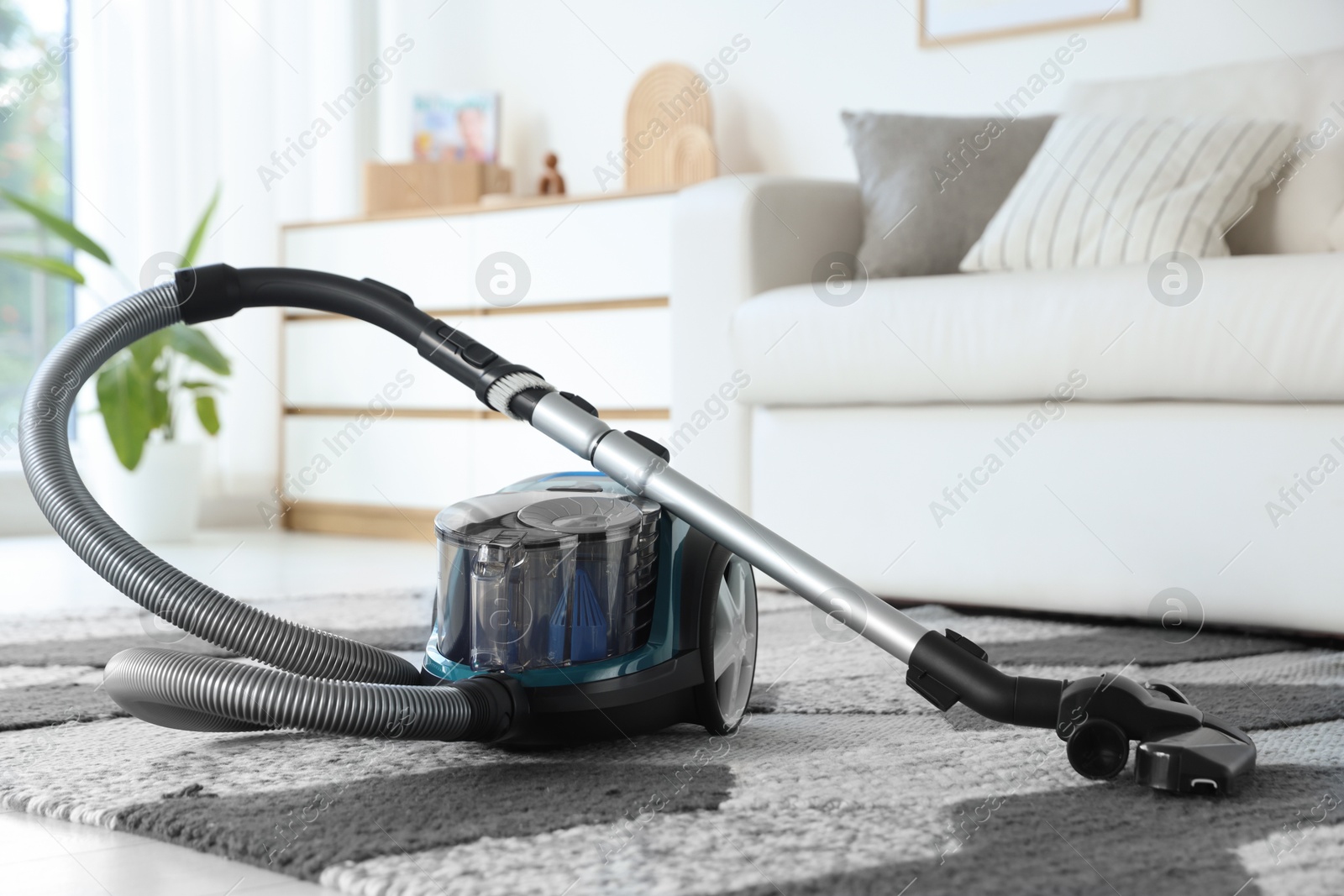 One vacuum cleaner on floor indoors. Household appliance Photo of One vacuum cleaner on floor indoors. Household appliance