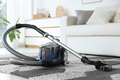 Photo of One vacuum cleaner on floor indoors. Household appliance