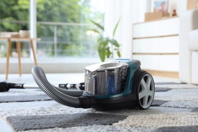 Photo of One vacuum cleaner on floor indoors. Household appliance
