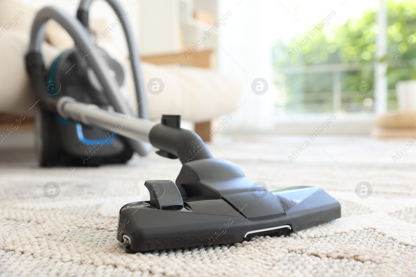 One vacuum cleaner on floor indoors, closeup. Household appliance Photo of One vacuum cleaner on floor indoors, closeup. Household appliance