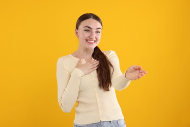 Photo of Beautiful woman laughing on yellow background. Positive emotion