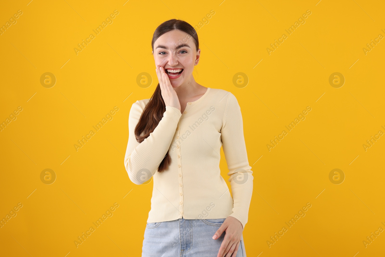Beautiful woman laughing on yellow background. Positive emotion Photo of Beautiful woman laughing on yellow background. Positive emotion