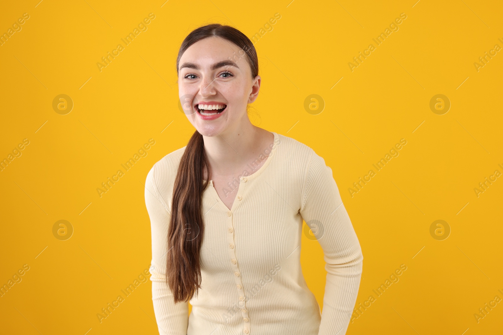 Beautiful woman laughing on yellow background. Positive emotion Photo of Beautiful woman laughing on yellow background. Positive emotion