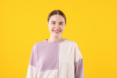Photo of Beautiful woman laughing on yellow background. Positive emotion