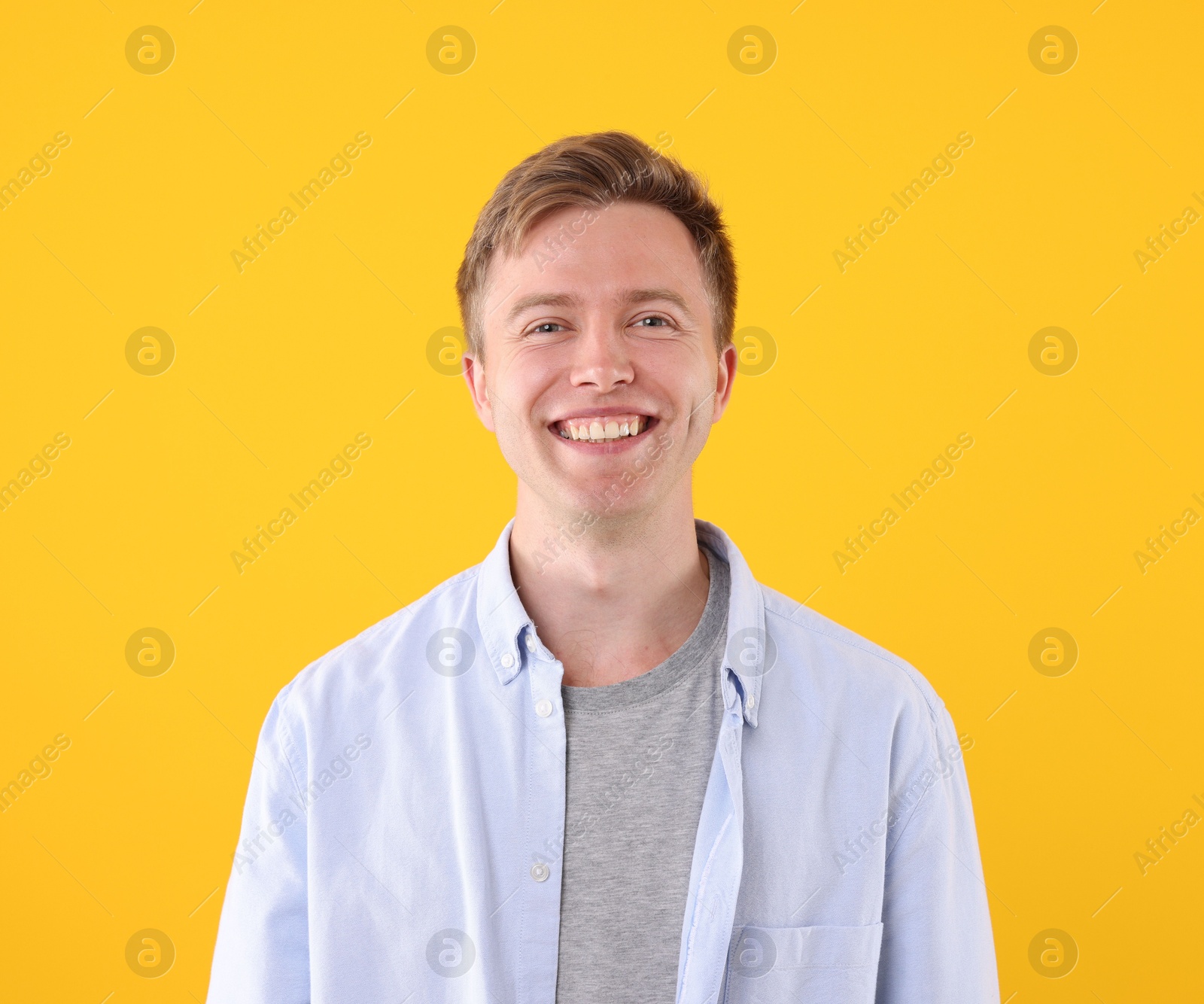 Handsome man laughing on yellow background. Positive emotion Photo of Handsome man laughing on yellow background. Positive emotion