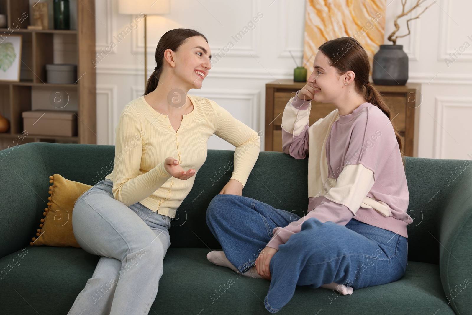 Friends laughing on sofa indoors. Positive emotion Photo of Friends laughing on sofa indoors. Positive emotion