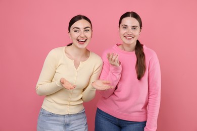 Photo of Beautiful women laughing on pink background. Positive emotion