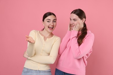 Photo of Beautiful women laughing on pink background. Positive emotion