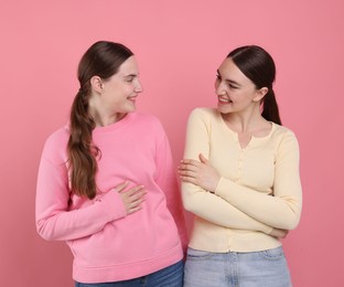 Photo of Beautiful women laughing on pink background. Positive emotion