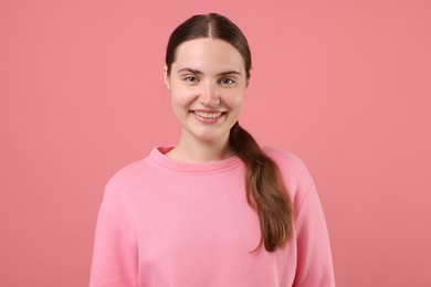 Photo of Beautiful woman laughing on pink background. Positive emotion