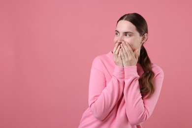 Photo of Beautiful woman laughing on pink background. Space for text