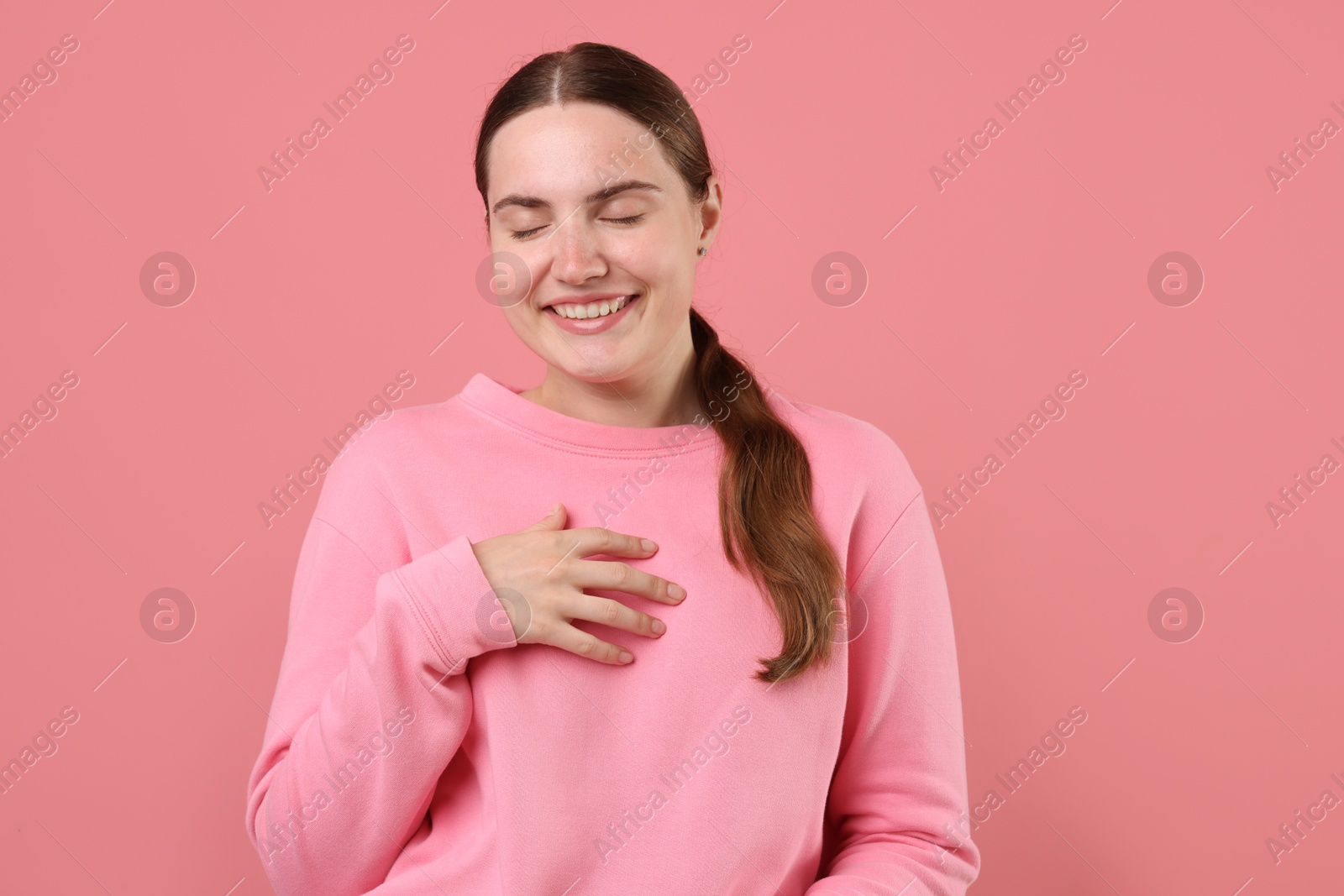 Beautiful woman laughing on pink background. Positive emotion Photo of Beautiful woman laughing on pink background. Positive emotion