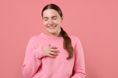 Photo of Beautiful woman laughing on pink background. Positive emotion