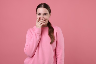Photo of Beautiful woman laughing on pink background. Positive emotion